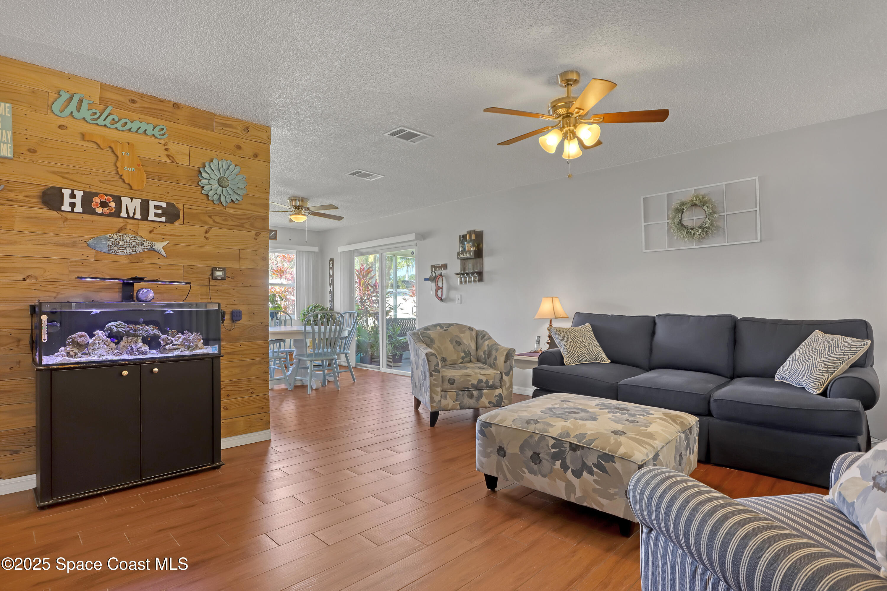 1513 Creel Road Northeast Palm Bay, FL 32905 - Photo 3 of 31 a living room with furniture a couch and a chandelier