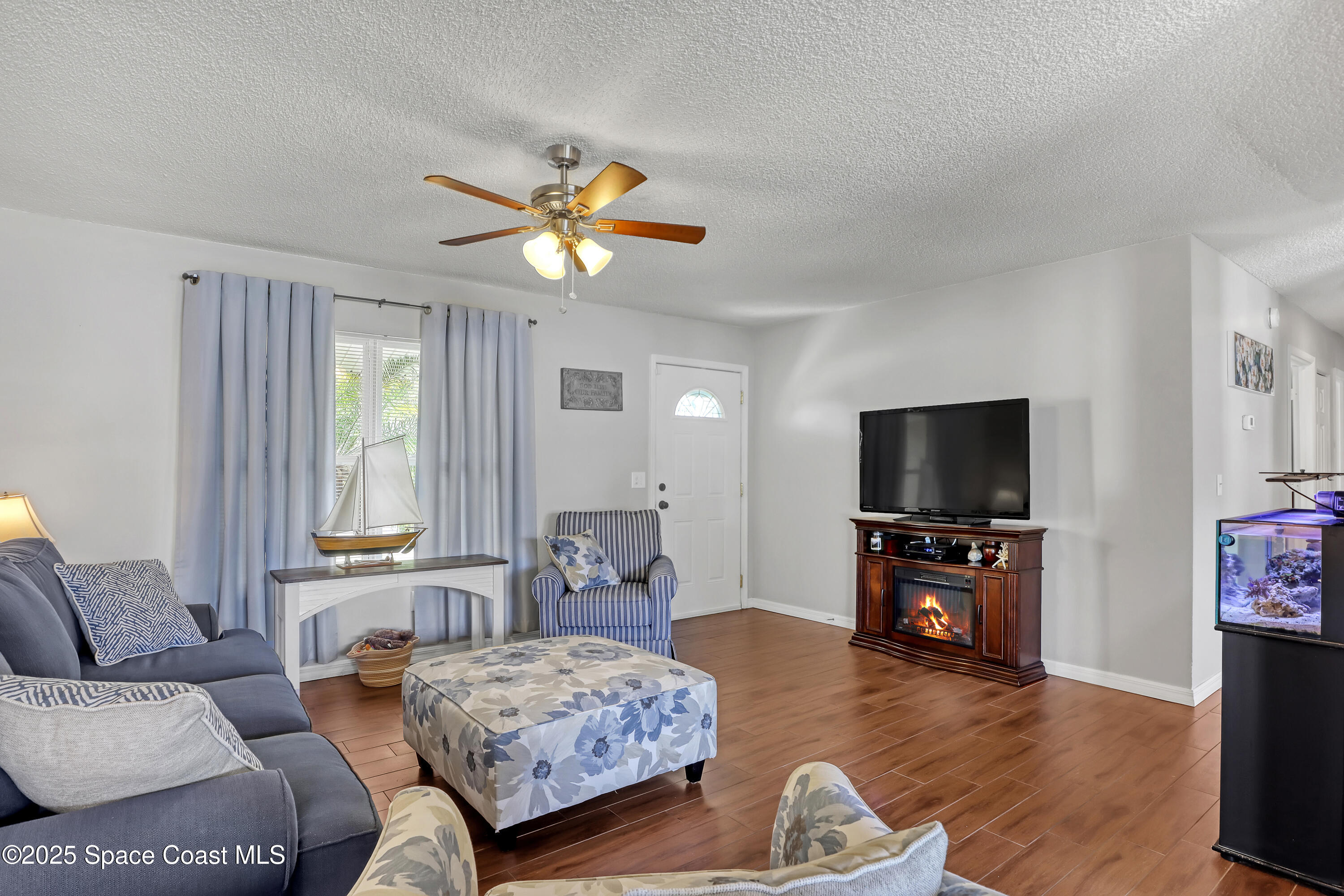 1513 Creel Road Northeast Palm Bay, FL 32905 - Photo 5 of 31 a bedroom with furniture and a flat screen tv