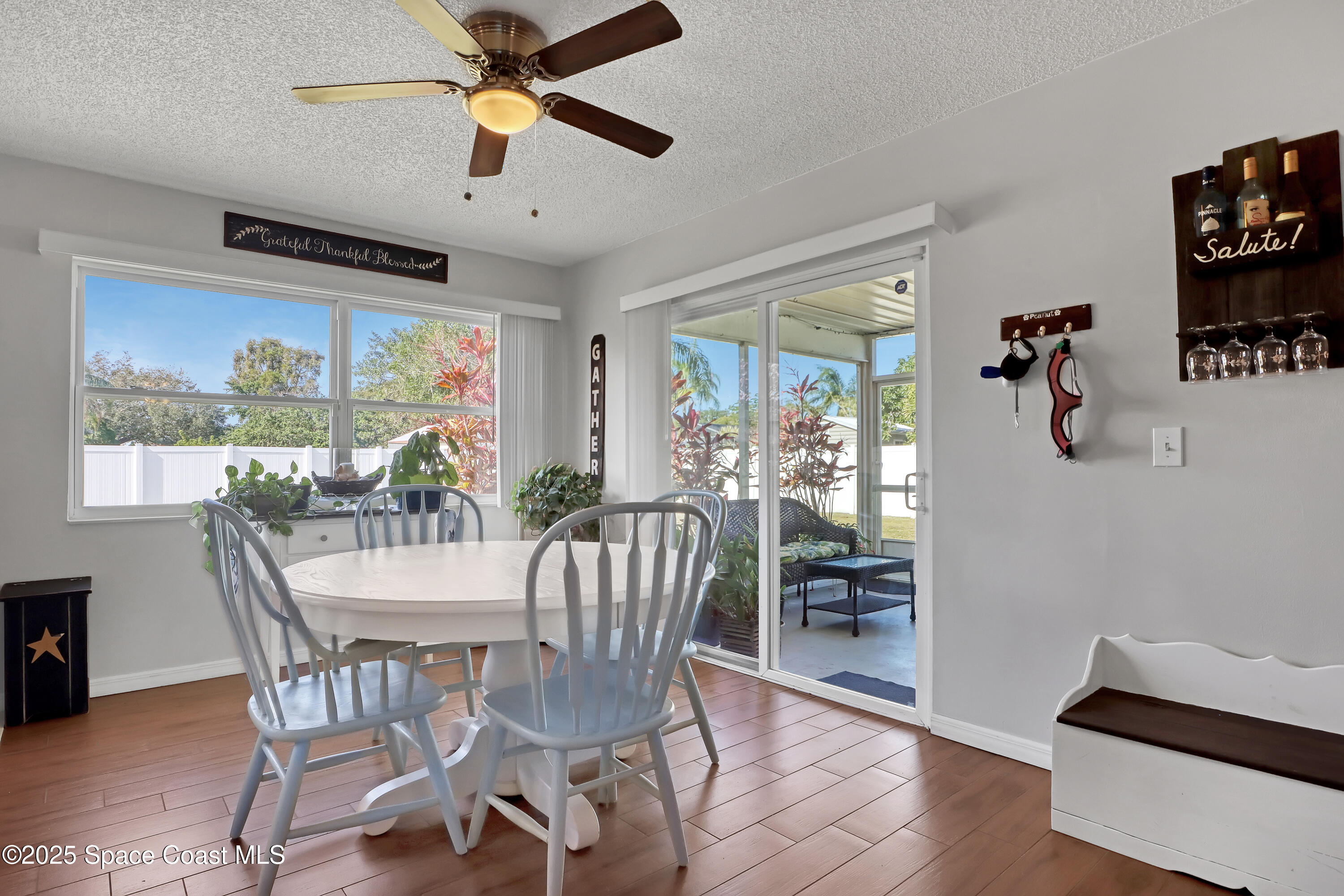 1513 Creel Road Northeast Palm Bay, FL 32905 - Photo 7 of 31 a view of a dining room with furniture window and wooden floor
