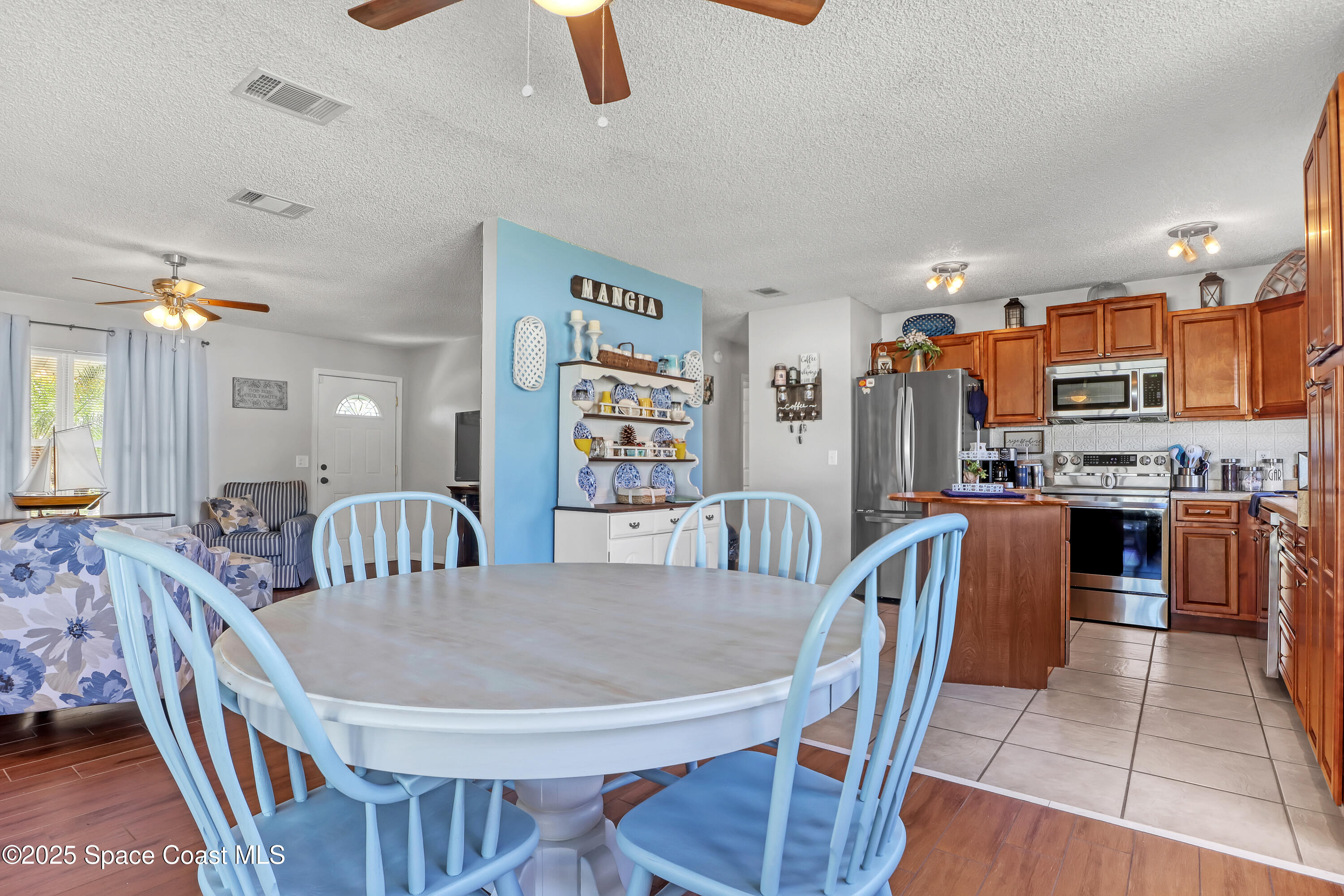 1513 Creel Road Northeast Palm Bay, FL 32905 - Photo 8 of 31 a dining room with furniture and wooden floor