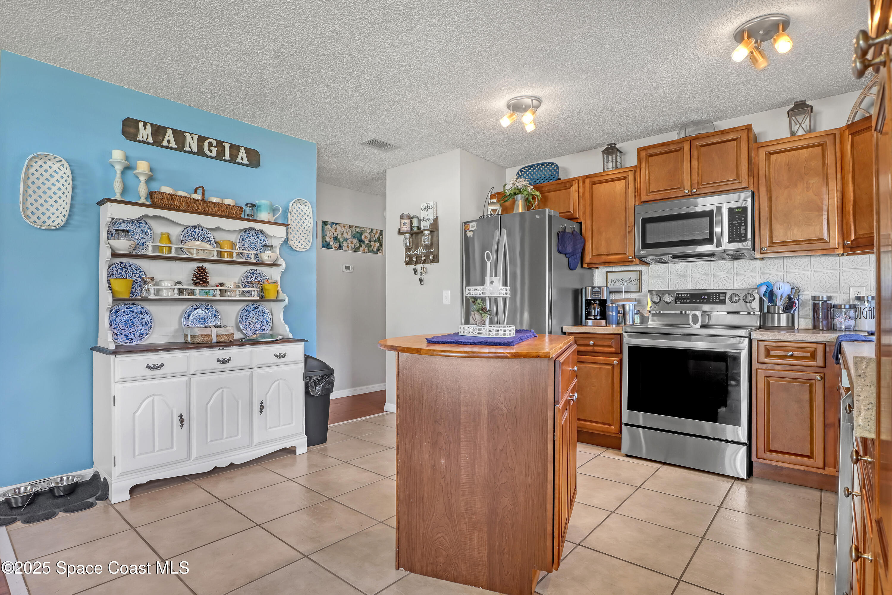 1513 Creel Road Northeast Palm Bay, FL 32905 - Photo 10 of 31 a kitchen with stainless steel appliances granite countertop a stove top oven a sink and dishwasher