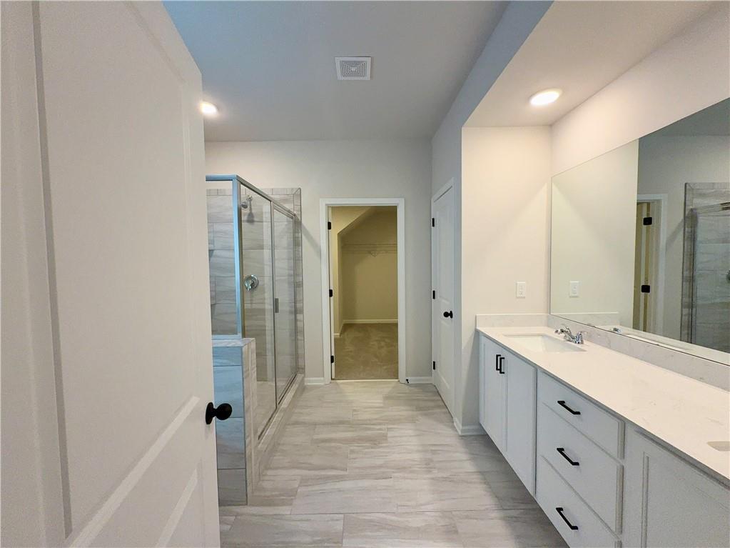 2225 Sun Valley Buford, GA 30519 - Photo 15 of 23 a spacious bathroom with a double vanity sink and a mirror
