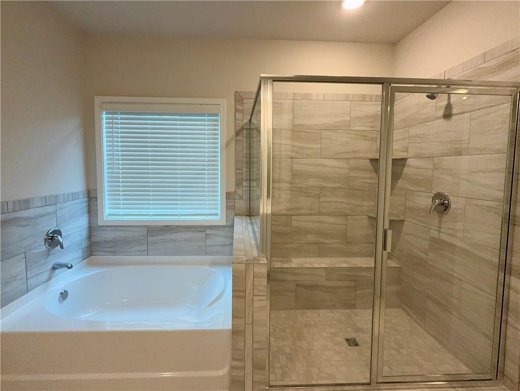 2225 Sun Valley Buford, GA 30519 - Photo 16 of 23 a bathroom with a shower and a bathtub
