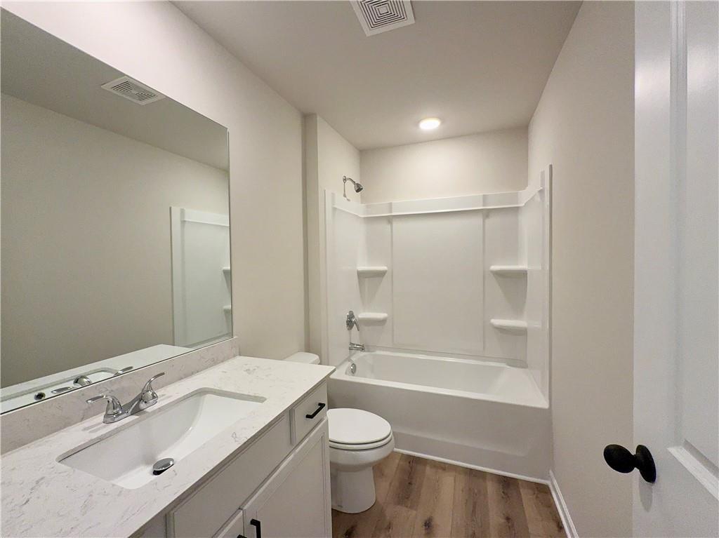 2225 Sun Valley Buford, GA 30519 - Photo 22 of 23 a bathroom with a granite countertop sink toilet and shower