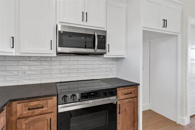 a kitchen with a stove and a microwave