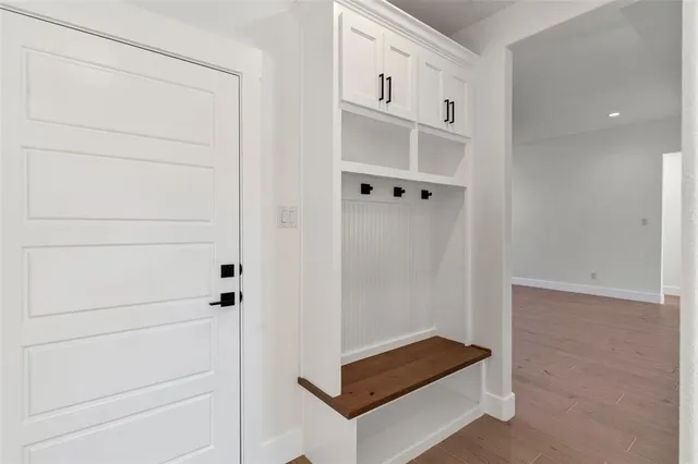a kitchen with granite countertop white cabinets and black appliances