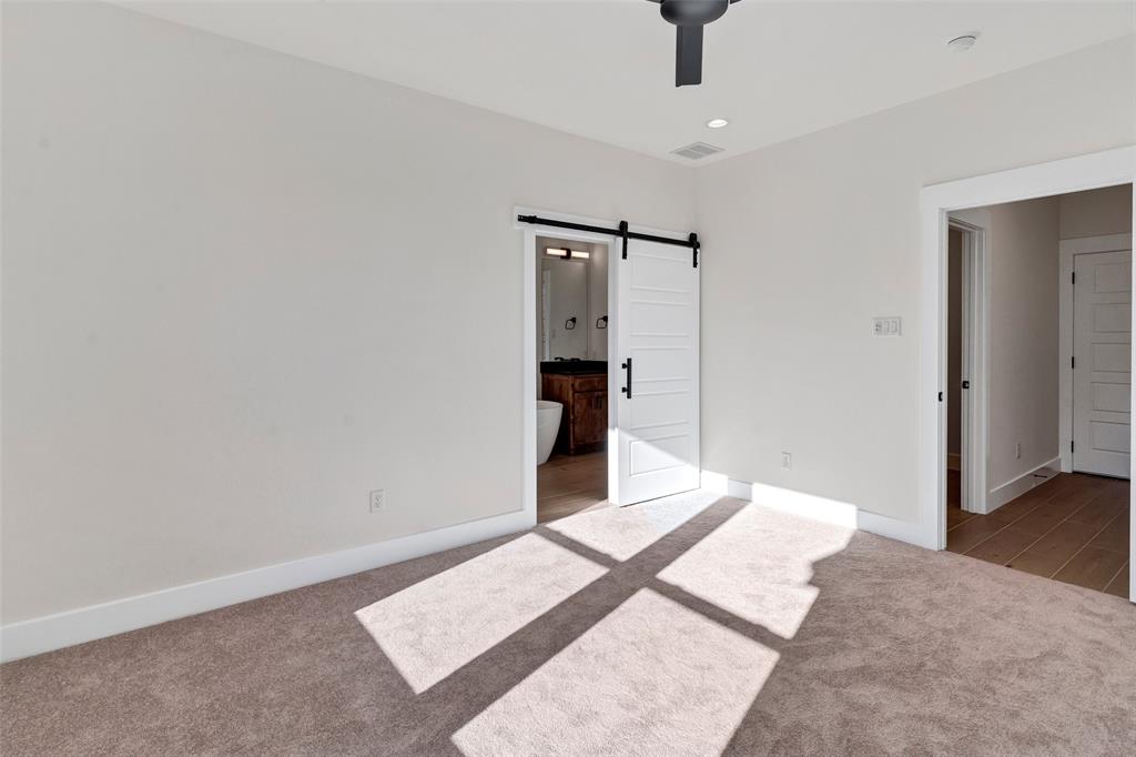 3306 Promenade Court Granbury, TX 76049 - Photo 23 of 40 a bedroom with a bed and a dresser