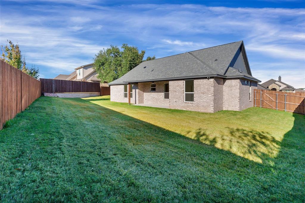 3306 Promenade Court Granbury, TX 76049 - Photo 35 of 40 a front view of a house with a yard