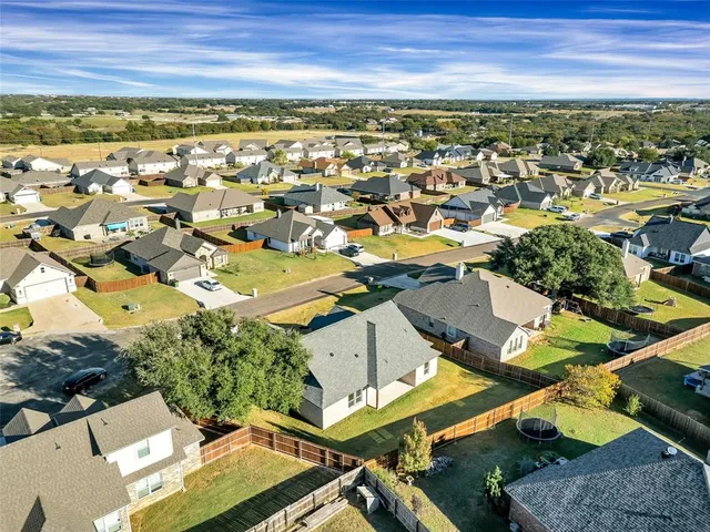an aerial view of residential houses with outdoor space
