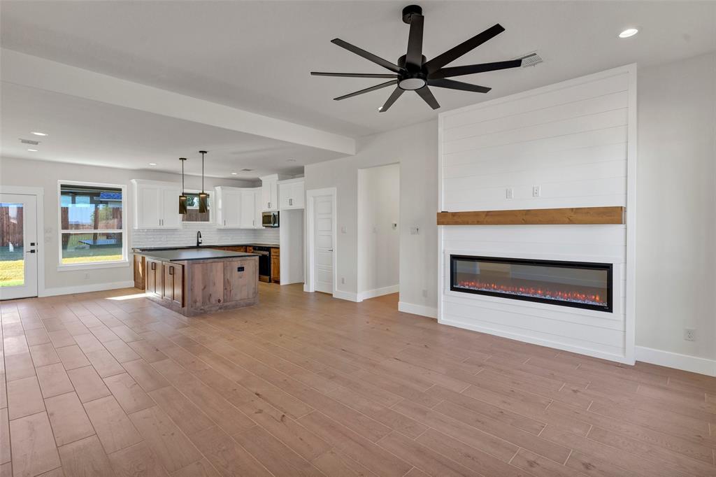 3306 Promenade Court Granbury, TX 76049 - Photo 7 of 40 a view of a kitchen with a stove cabinets and a ceiling fan