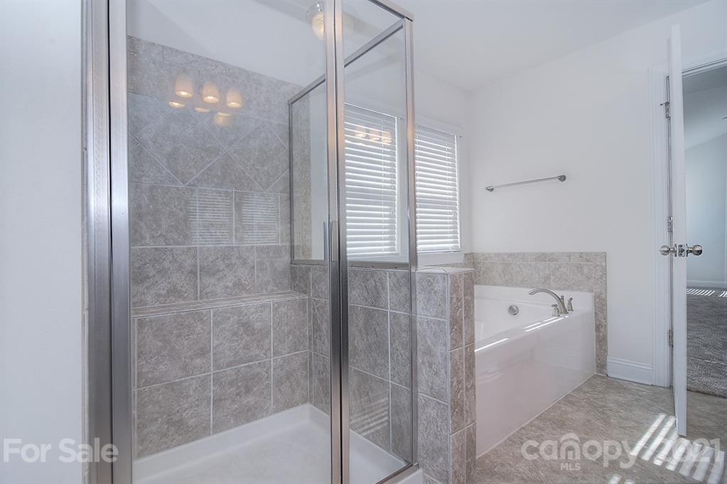 2001 Fallondale Road Waxhaw, NC 28173 - Photo 17 of 36 a bathroom with a bathtub and a shower