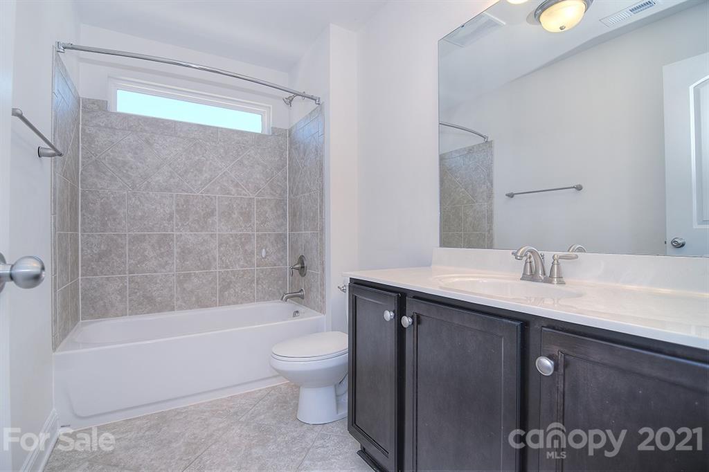 2001 Fallondale Road Waxhaw, NC 28173 - Photo 20 of 36 a bathroom with a bathtub shower sink vanity and toilet