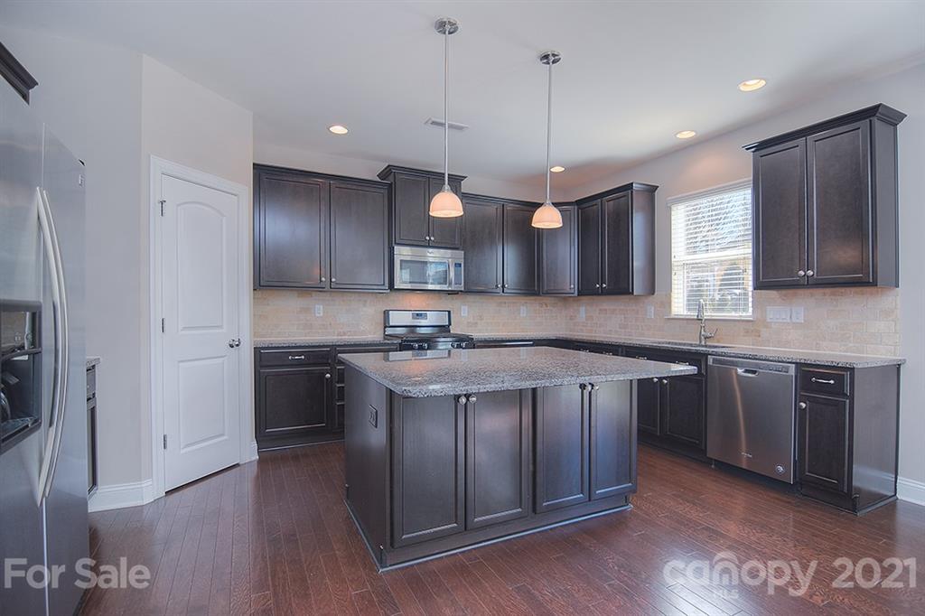 2001 Fallondale Road Waxhaw, NC 28173 - Photo 26 of 36 a kitchen with a sink cabinets and wooden floor