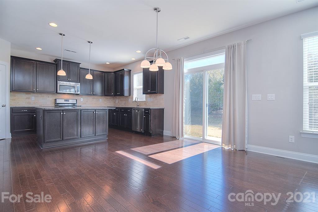 2001 Fallondale Road Waxhaw, NC 28173 - Photo 6 of 36 a view of a kitchen with granite countertop stainless steel appliances and a fireplace