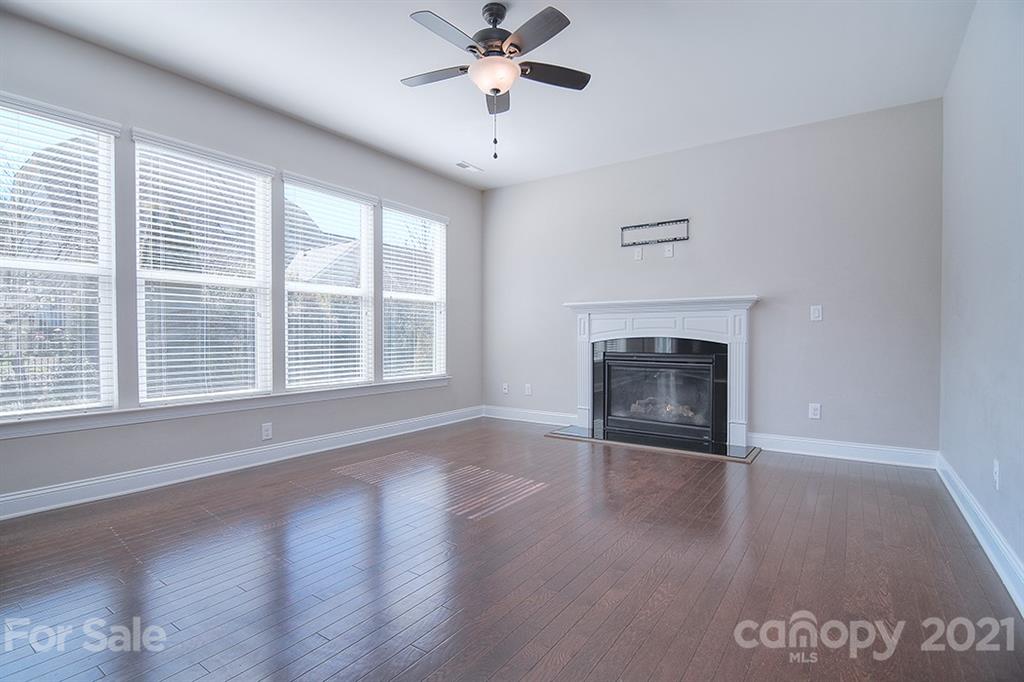 2001 Fallondale Road Waxhaw, NC 28173 - Photo 9 of 36 a view of empty room with wooden floor and fireplace
