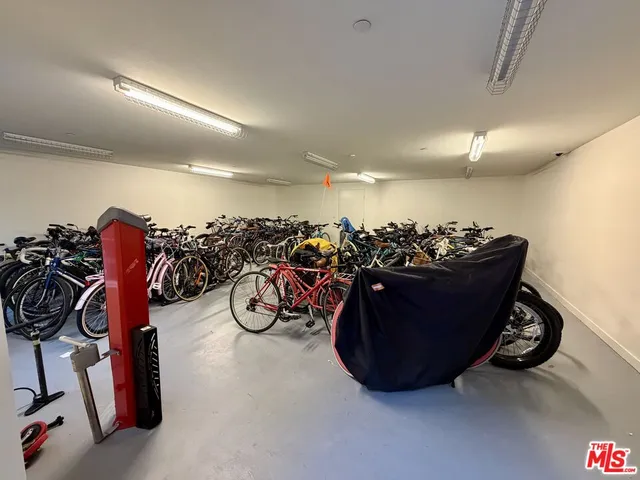 a living room with furniture a desk and a potted plant