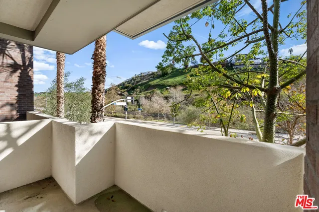 a view of a balcony and trees