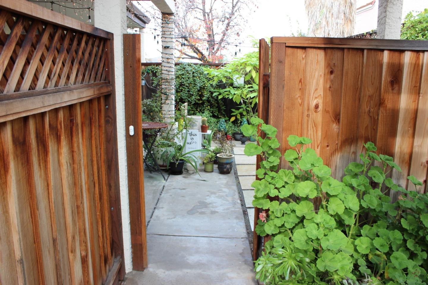 4944 Canto Drive San Jose, CA 95124 - Photo 20 of 20 a backyard with potted plants and wooden fence