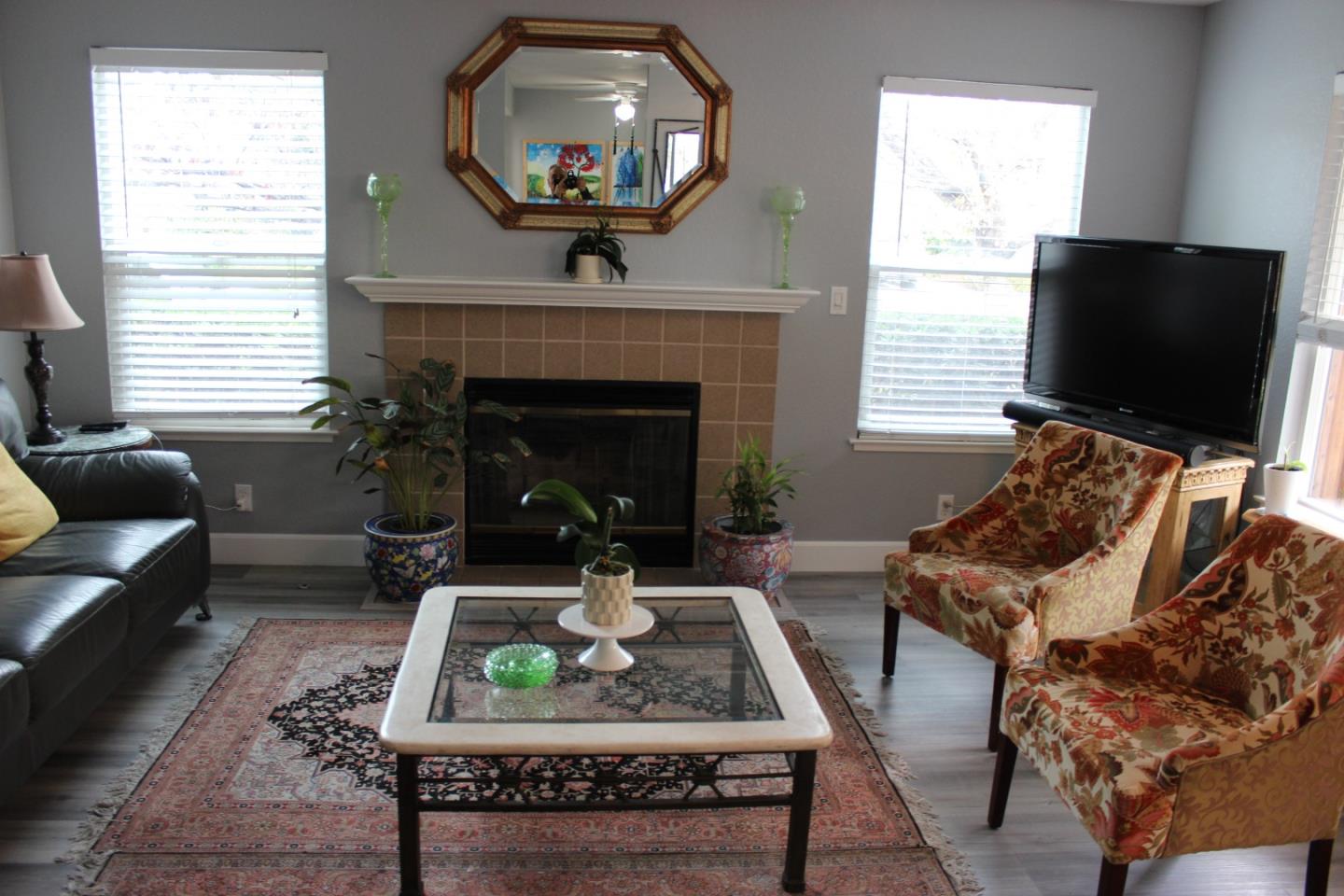 4944 Canto Drive San Jose, CA 95124 - Photo 3 of 20 a living room with furniture a flat screen tv and a fireplace
