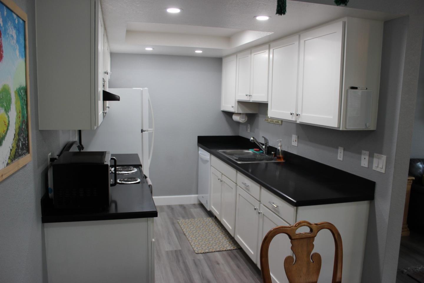 4944 Canto Drive San Jose, CA 95124 - Photo 8 of 20 a kitchen with granite countertop a stove and a sink