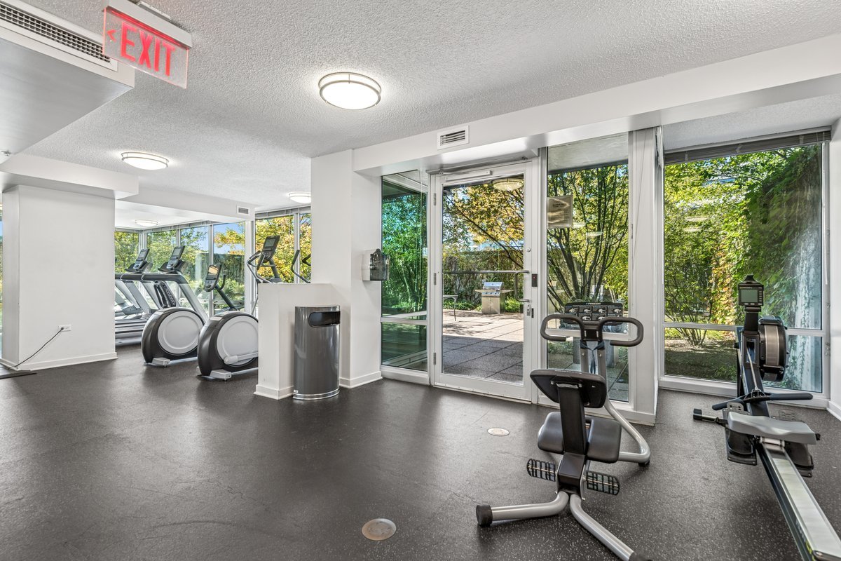 800 Elgin Road, Unit 909 Evanston, IL 60201 - Photo 13 of 15 a view of a room with gym equipment and floor to ceiling window
