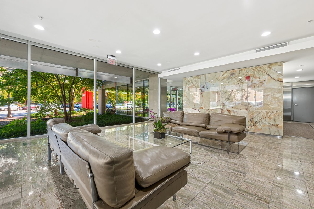 800 Elgin Road, Unit 909 Evanston, IL 60201 - Photo 15 of 15 a living room with patio furniture and a floor to ceiling window