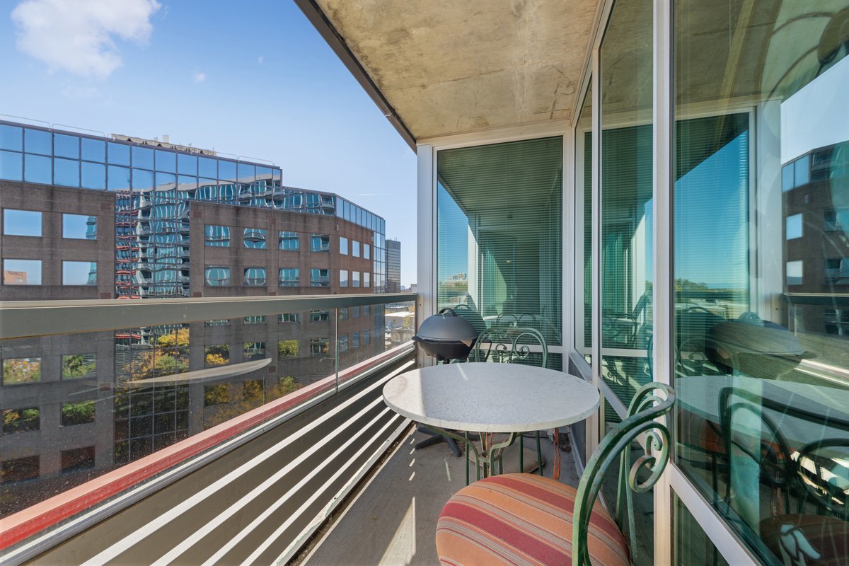 800 Elgin Road, Unit 909 Evanston, IL 60201 - Photo 3 of 15 a balcony with table and chairs