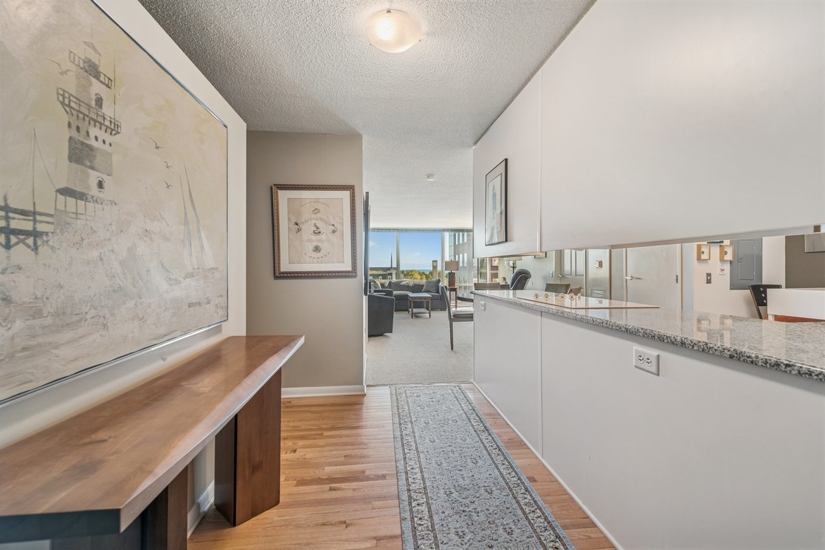 800 Elgin Road, Unit 909 Evanston, IL 60201 - Photo 4 of 15 a kitchen with granite countertop lots of counter top space and wooden floor