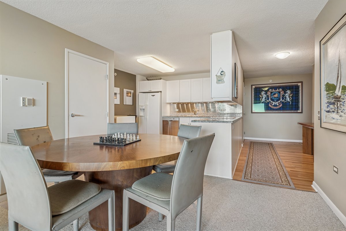 800 Elgin Road, Unit 909 Evanston, IL 60201 - Photo 6 of 15 a view of a dining room with furniture and wooden floor