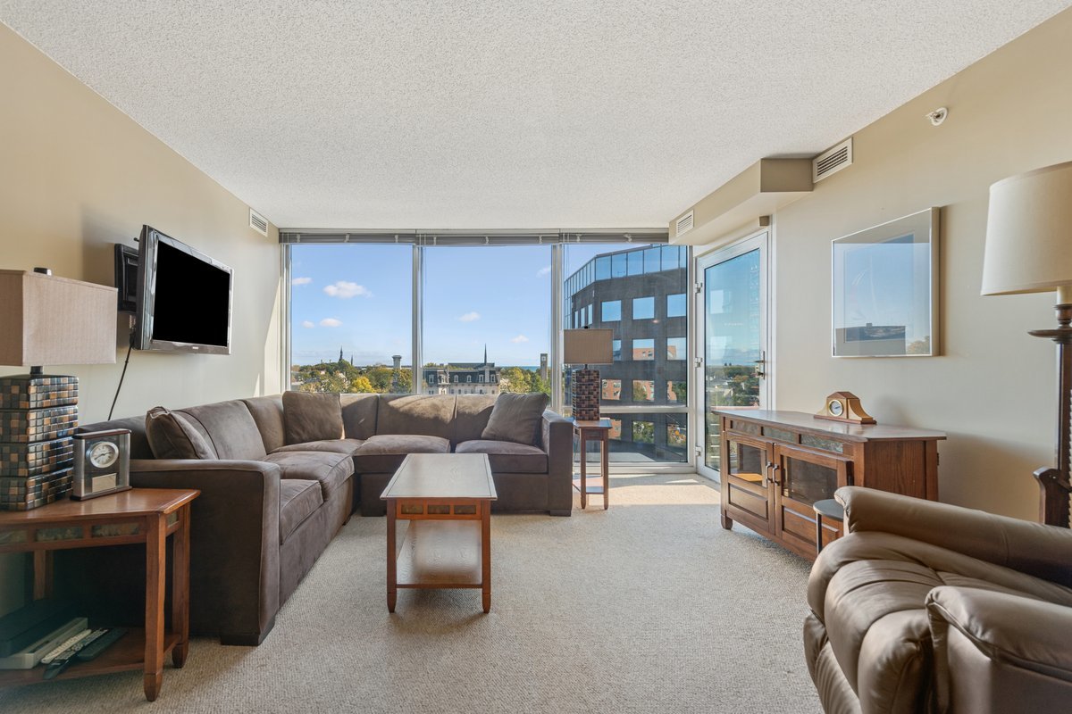 800 Elgin Road, Unit 909 Evanston, IL 60201 - Photo 7 of 15 a living room with furniture and a flat screen tv