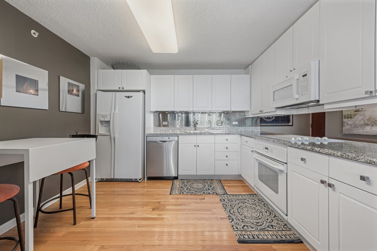 800 Elgin Road, Unit 909 Evanston, IL 60201 - Photo 8 of 15 a kitchen with stainless steel appliances granite countertop a refrigerator sink and cabinets