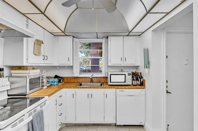 a kitchen with stainless steel appliances granite countertop a sink and refrigerator
