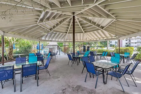 a view of a house with swimming pool and sitting area