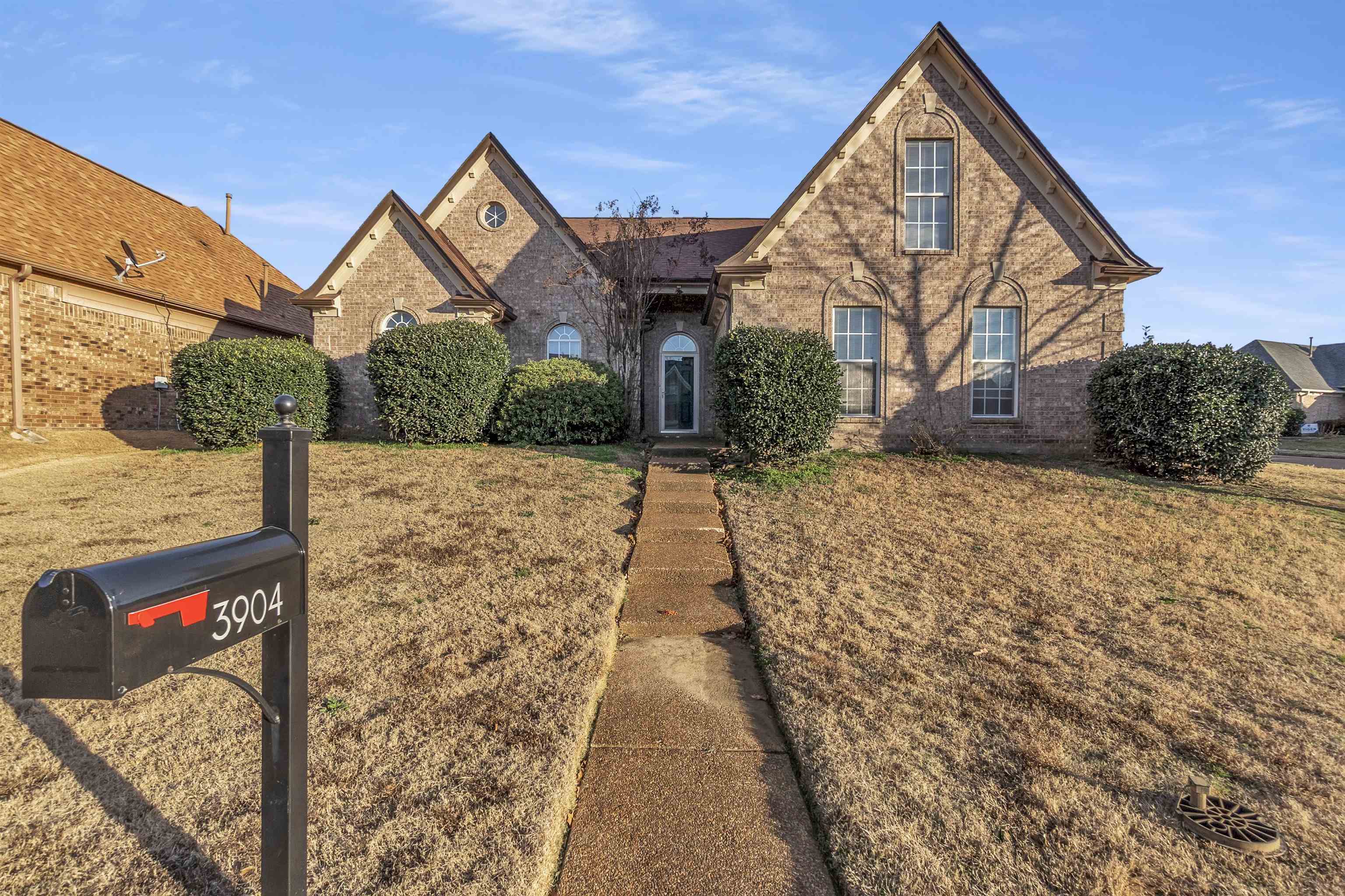 3904 August Moon Cove Memphis, TN 38135 - Photo 1 of 25 a view of a brick house with wooden fence