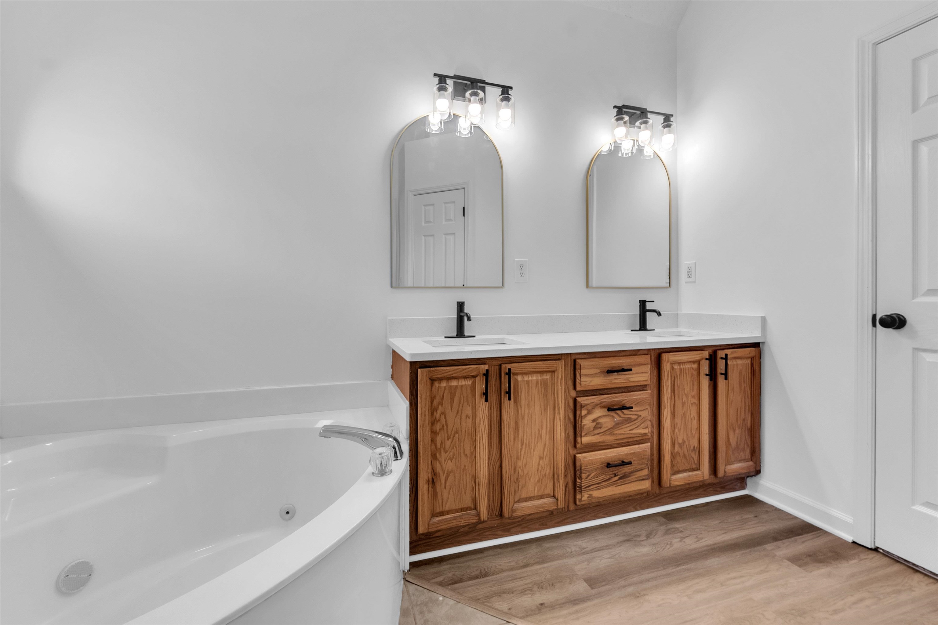 3904 August Moon Cove Memphis, TN 38135 - Photo 17 of 25 a bathroom with a tub sink and mirror