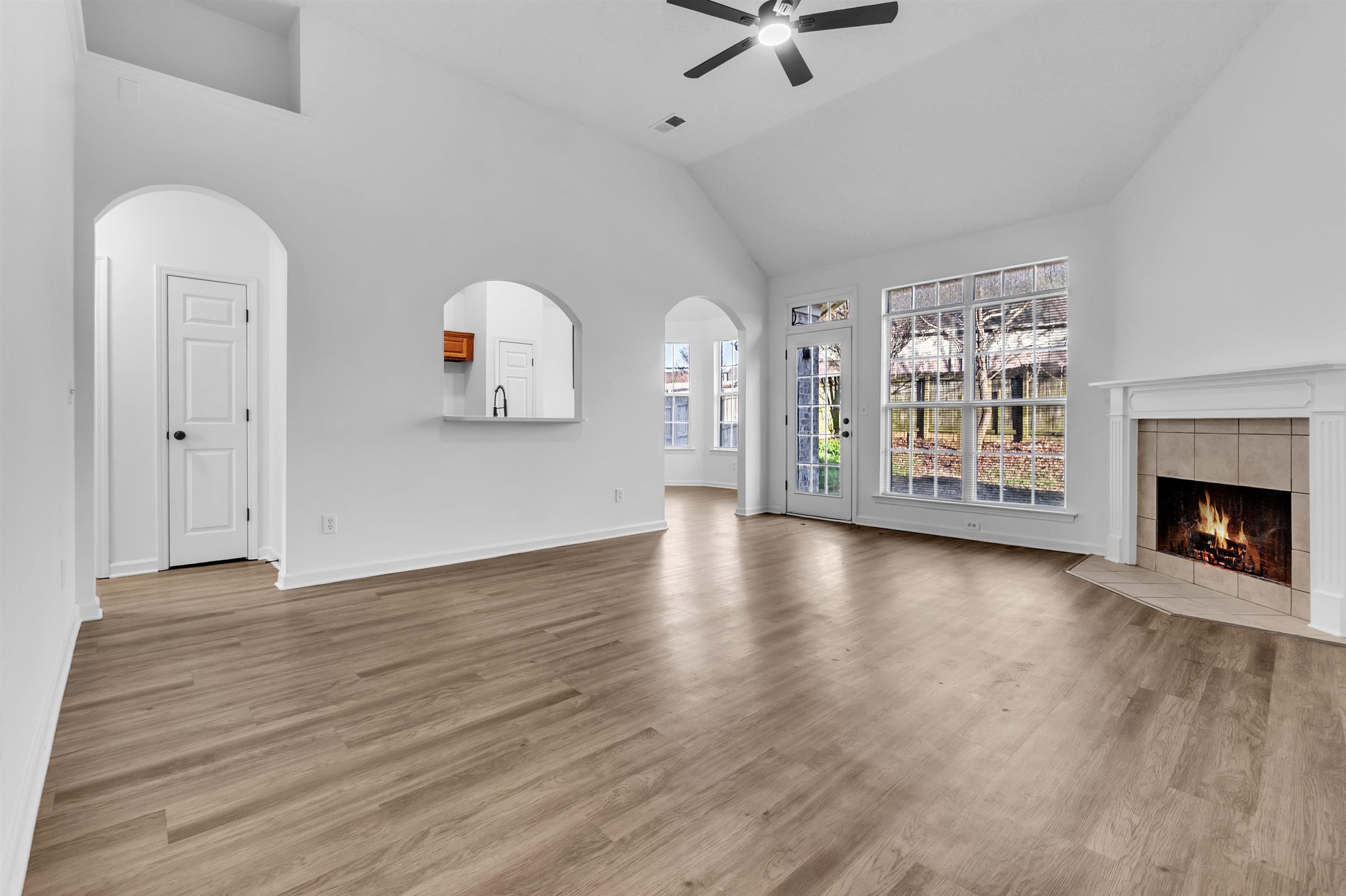 3904 August Moon Cove Memphis, TN 38135 - Photo 2 of 25 wooden floor in an empty room with a fireplace