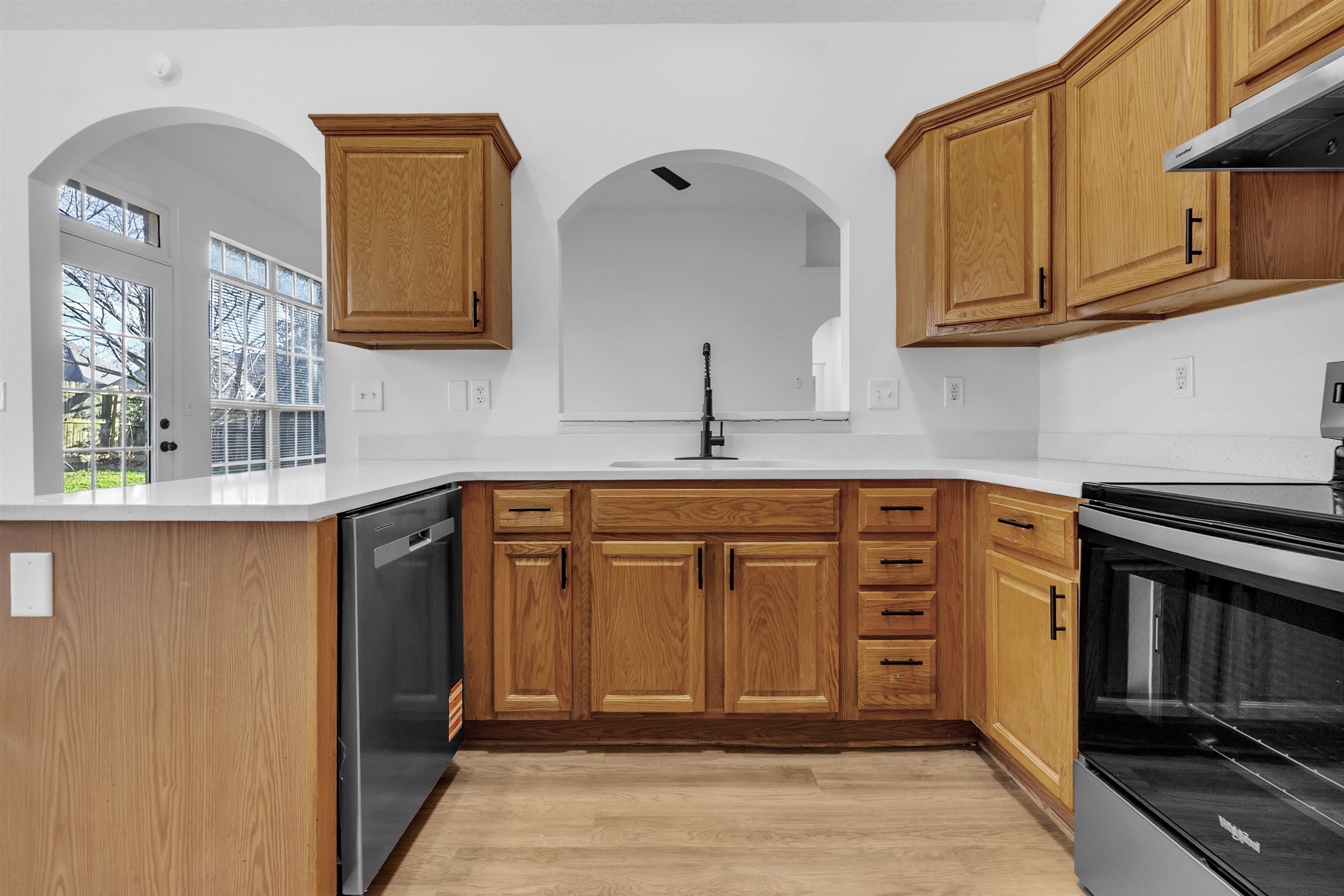3904 August Moon Cove Memphis, TN 38135 - Photo 4 of 25 a kitchen with stainless steel appliances granite countertop a sink stove and cabinets