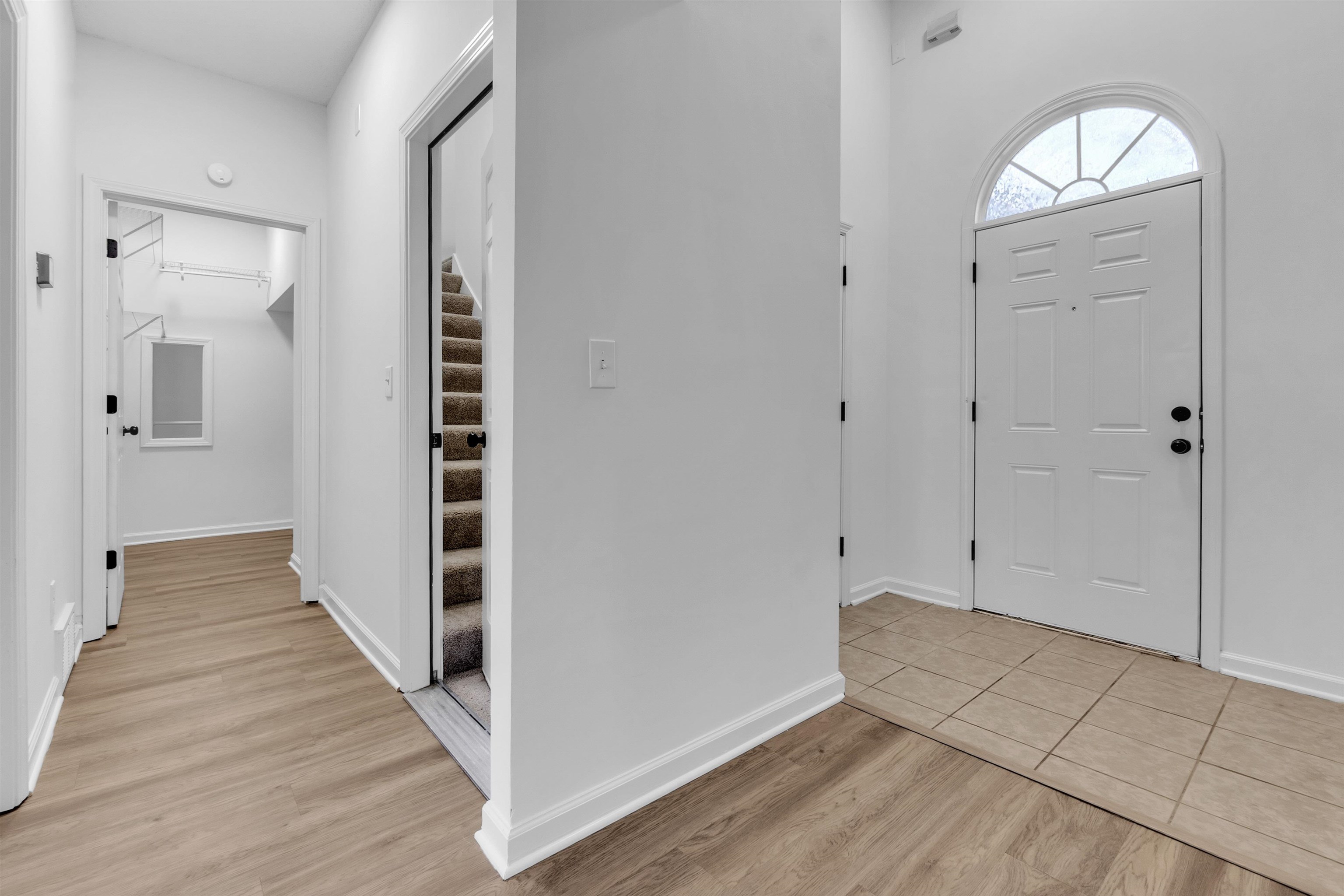 3904 August Moon Cove Memphis, TN 38135 - Photo 7 of 25 a view of a hallway with wooden floor and staircase