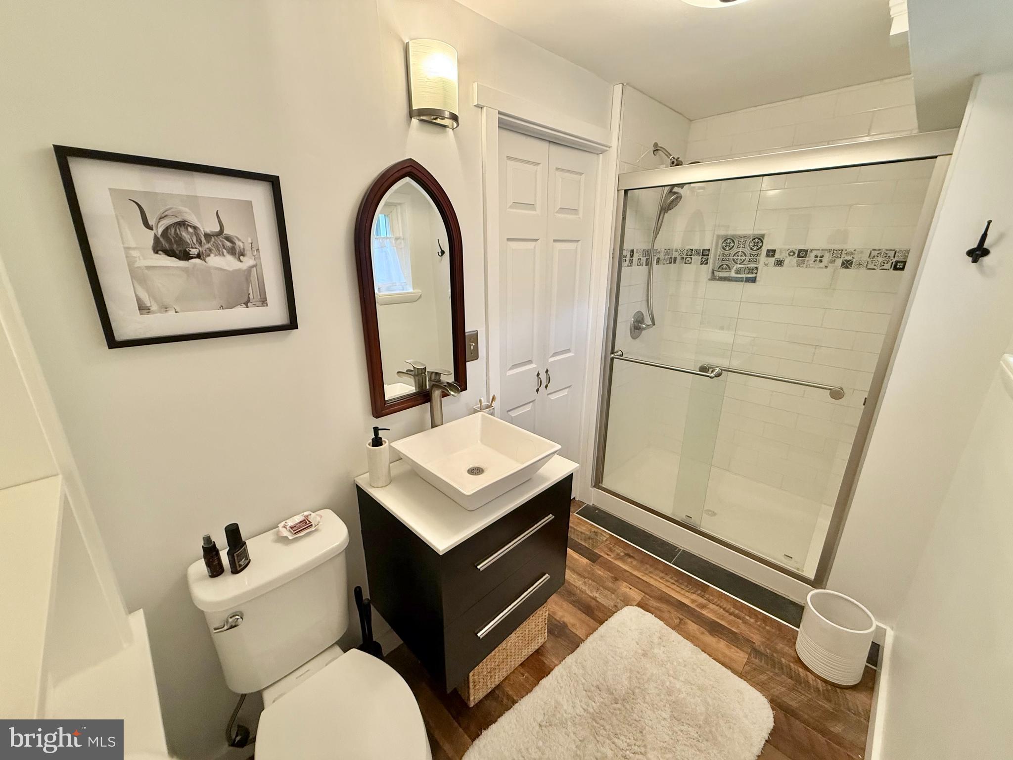 1303 Bruce Road Oreland, PA 19075 - Photo 13 of 13 a bathroom with a sink mirror vanity and toilet