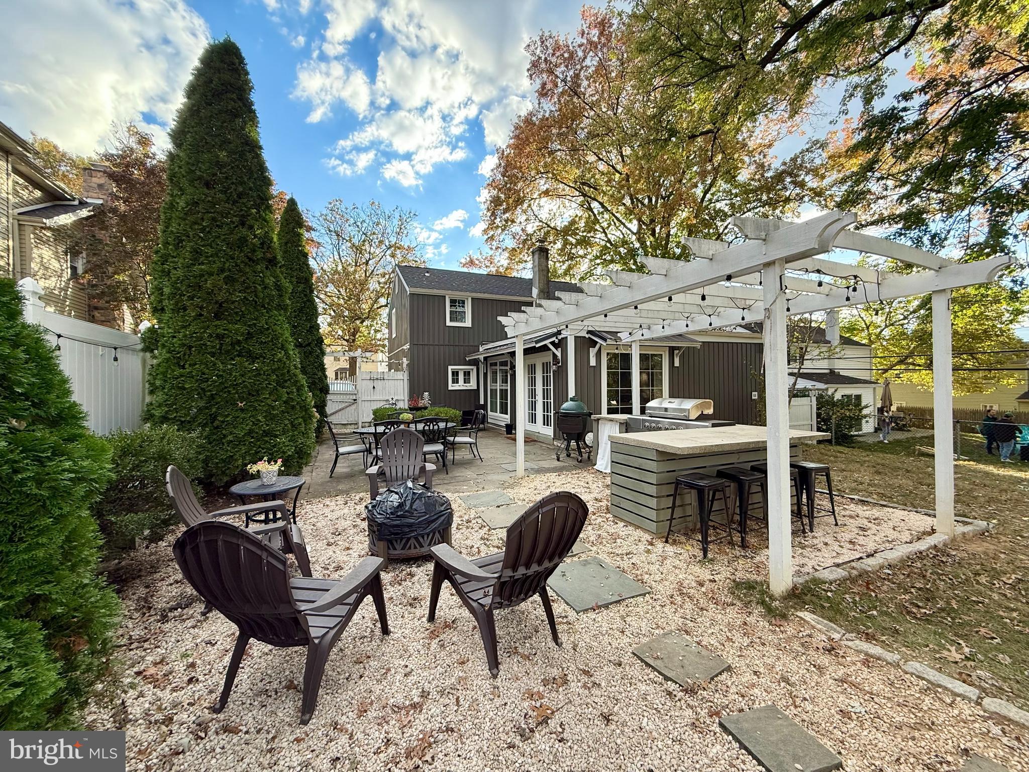 1303 Bruce Road Oreland, PA 19075 - Photo 2 of 13 a view of a patio with table and chairs and potted plants