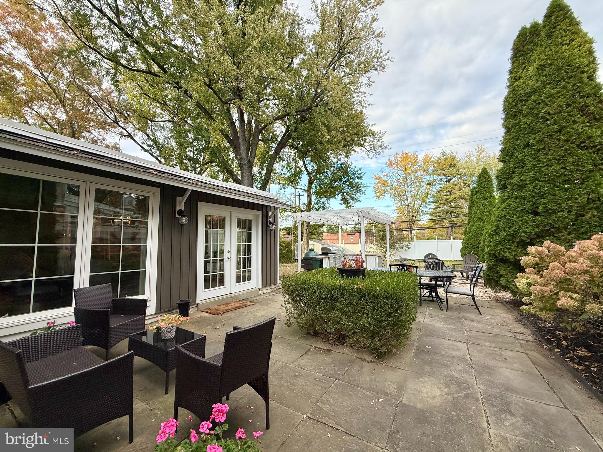 1303 Bruce Road Oreland, PA 19075 - Photo 3 of 13 a view of a patio with couches table and chairs and potted plants