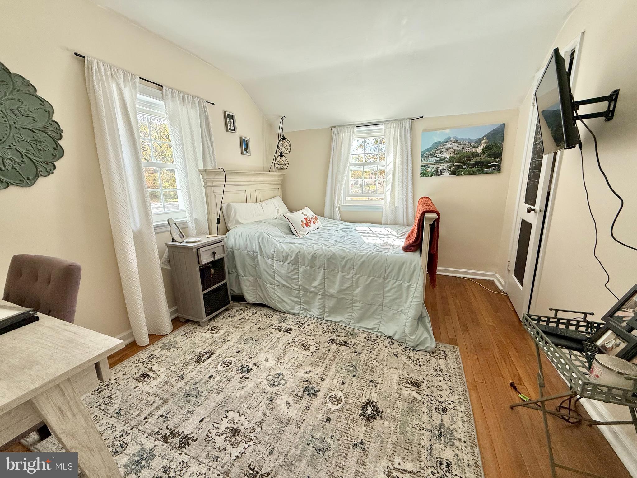 1303 Bruce Road Oreland, PA 19075 - Photo 7 of 13 a bedroom with a bed and wooden floor