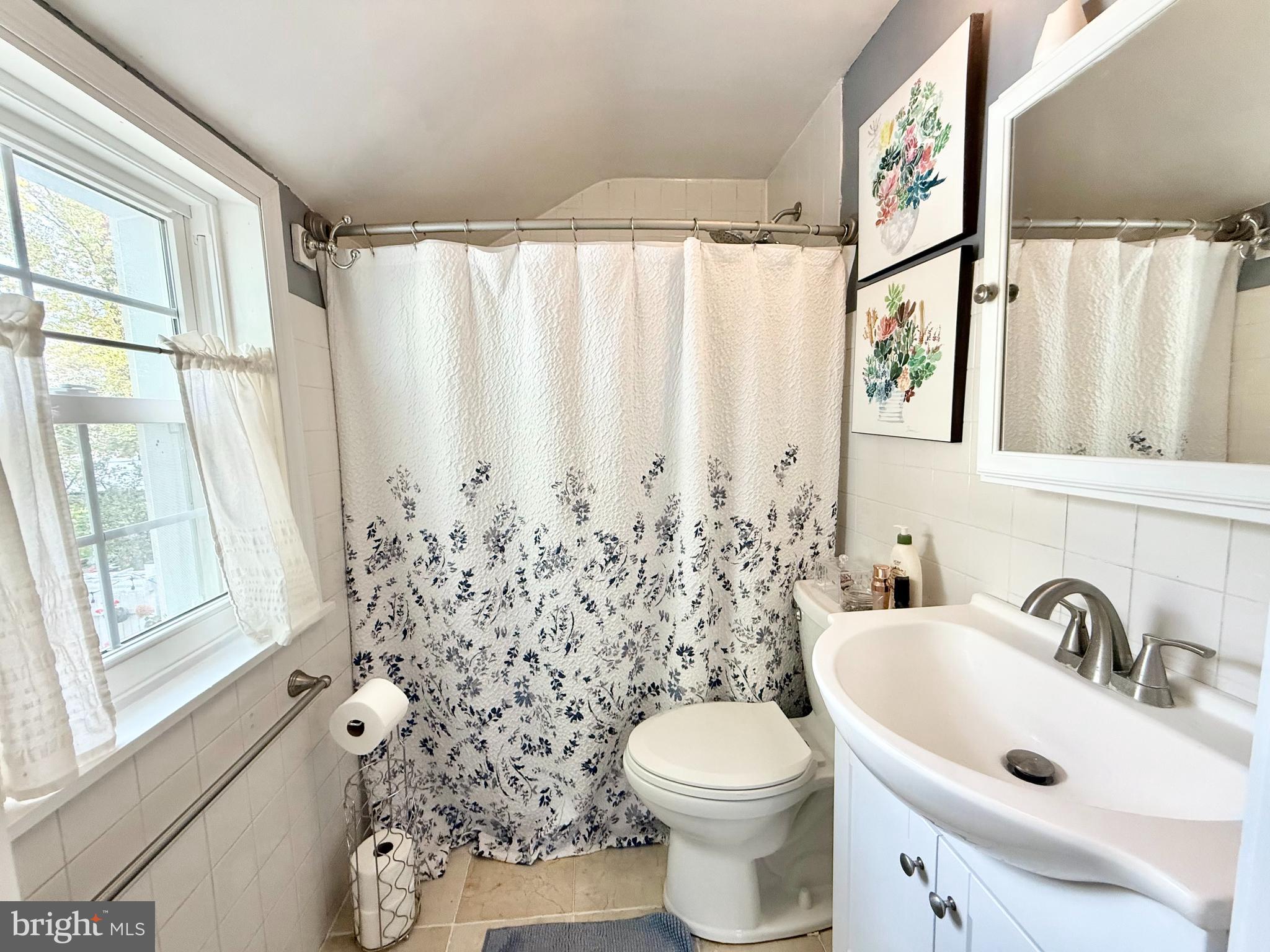 1303 Bruce Road Oreland, PA 19075 - Photo 9 of 13 a white toilet sitting next to a bathroom sink