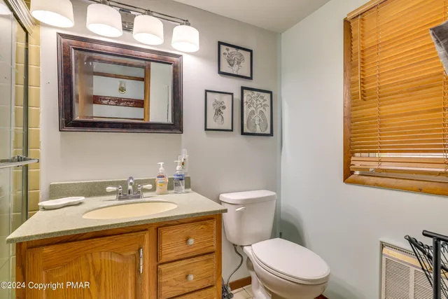 a bathroom with a granite countertop shower a sink and a mirror