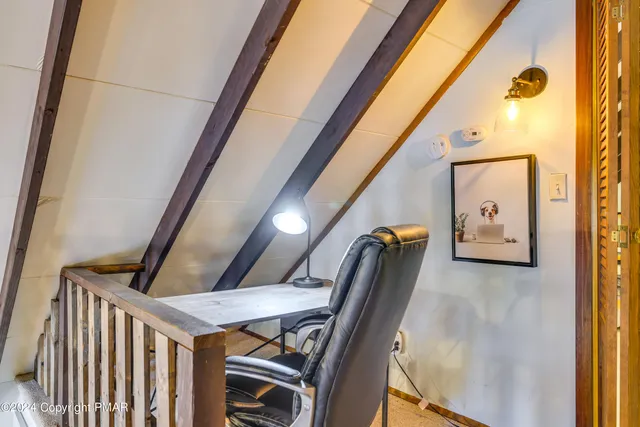 a view of bedroom with furniture and lamp