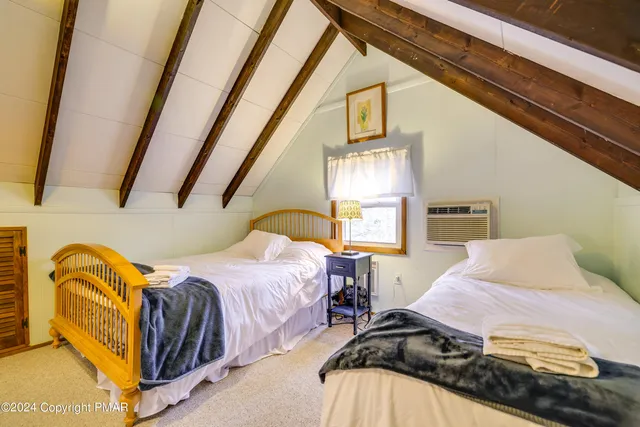 a bedroom with bed and balcony