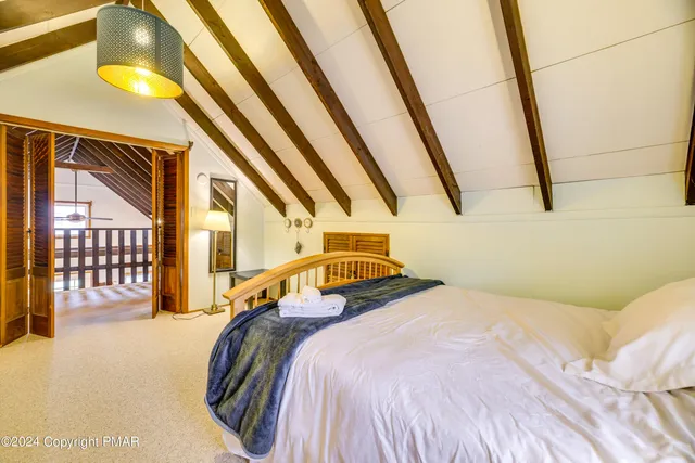 a living room with furniture a rug and a large window