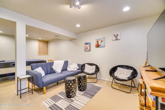 a bedroom with bed and a flat screen tv