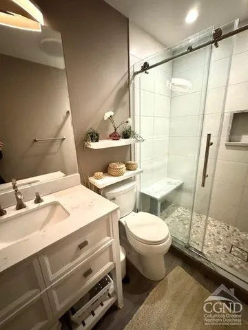 a bathroom with a shower and a sink