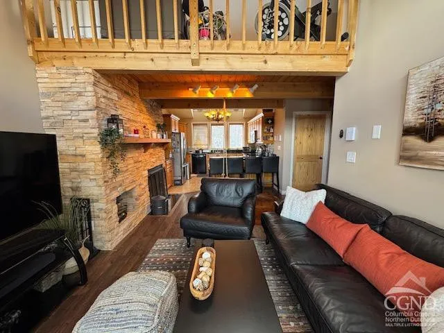 a living room with furniture large window and a fireplace